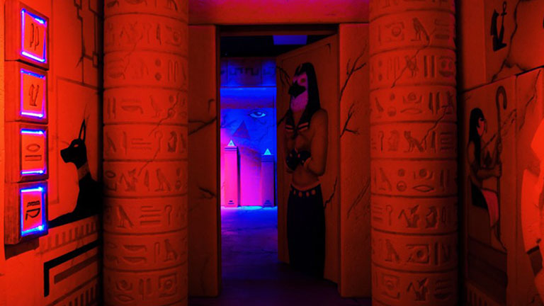 The hallway inside our Egyptian themed escape room with pillars covered in hieroglyphics.